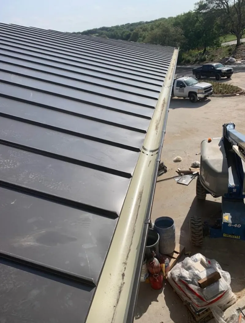 Standing seam panel and gutter detail on a metal roofing jobsite in Rancho Mirage